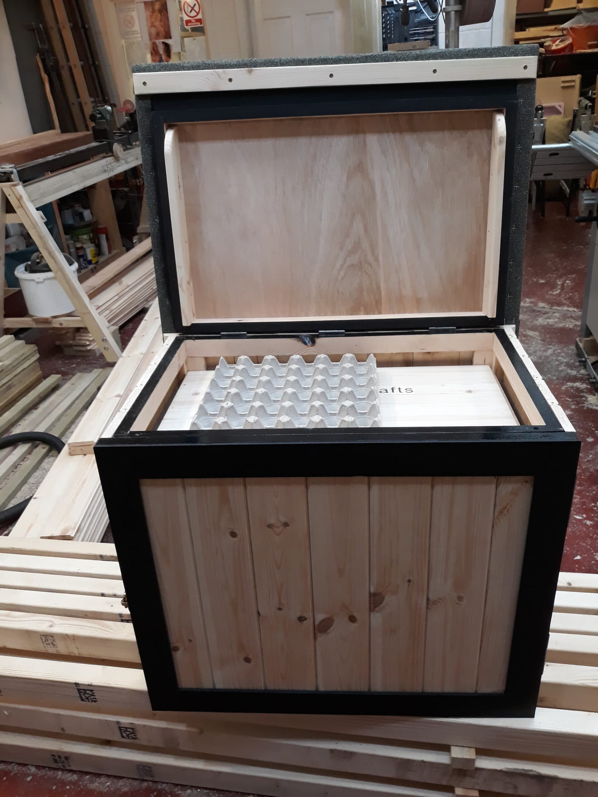 Large handcrafted wooden delivery box on a doorstep