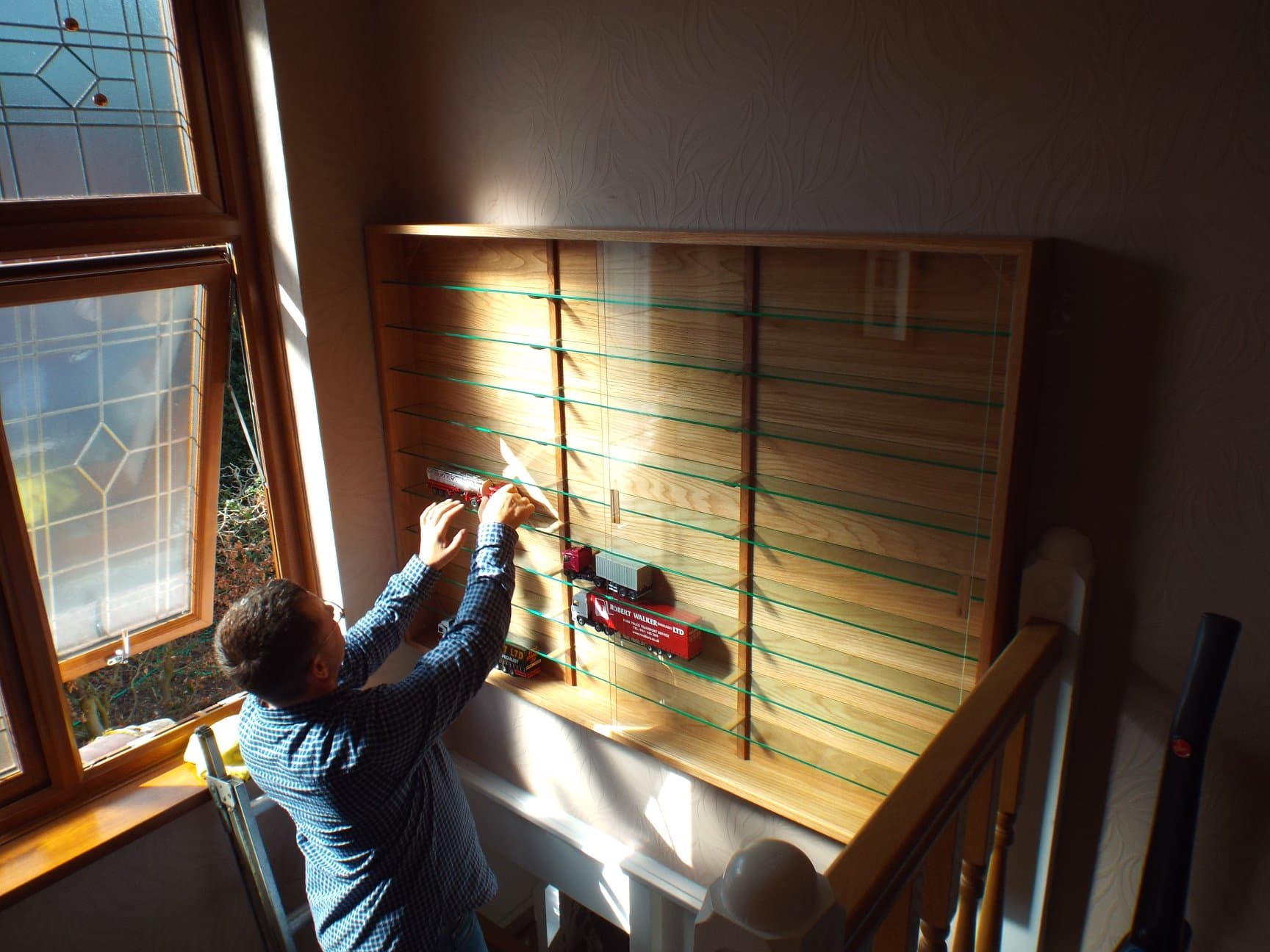 Tall oak display cabinet with glass doors