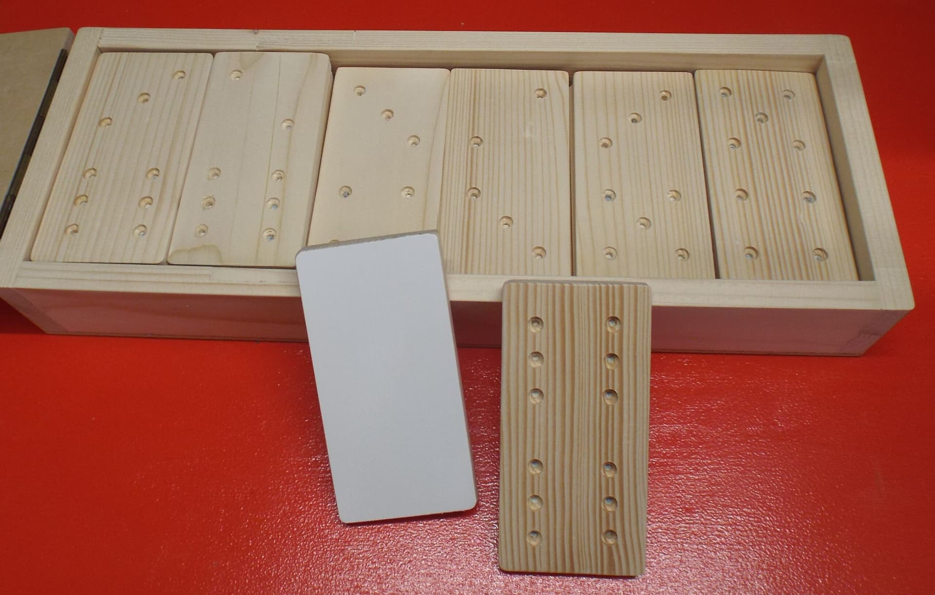 Large wooden domino tiles displayed on a table