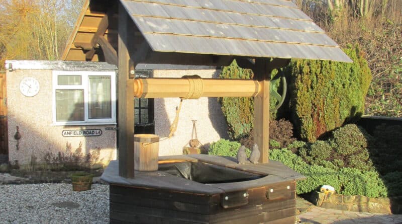 Aged wooden wishing well with weathered finish